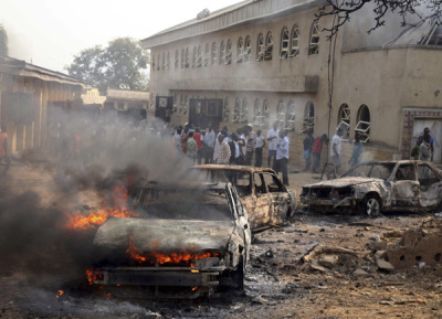 A car burns at the scene of a bomb explosion at St. Theresa Catholic Church at Madalla, Suleja, just outside Nigeria's capital Abuja, December 25, 2011. Five bombs exploded on Christmas Day at churches in Nigeria, one killing at least 27 people, raising fears that Islamist militant group Boko Haram - which claimed responsibility - is trying to ignite sectarian civil war.