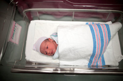 Newborn baby Makenzie, daughter of Stephanie Sanchez, 25, and Kenneth Vega, is wheeled to a nursery after she was born at 10:25am at Wyckoff Heights Medical Center in the Brooklyn borough of New York October 31, 2011.