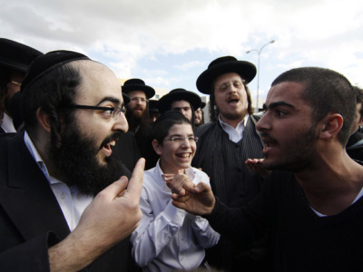 Orthodox and secular Jews exchange comments at a demonstration Monday in the town of Beit Shemesh, near Jerusalem. Orthodox Jews argue for gender segregation, while secular Jews plan a rally Tuesday to assert gender equality.