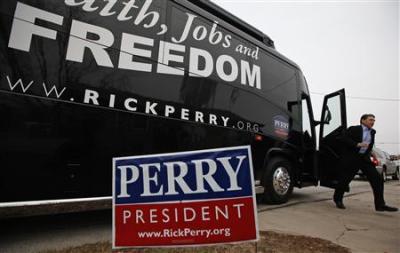 U.S. Republican Presidential candidate and Texas Governor Rick Perry steps off his bus on his way to a campaign stop in Storm Lake, Iowa, December 16, 2011.