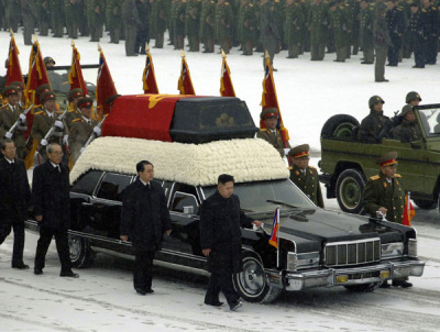 Kim Jong-un (front C) and his uncle Jang Song-thaek (L from Kim) accompany the hearse carrying the coffin of late North Korean leader Kim Jong-il during his funeral procession in Pyongyang December 28, 2011. North Korea's military staged a huge funeral procession on Wednesday in the snowy streets of the capital Pyongyang, readying a transition to his son, Kim Jong-un.