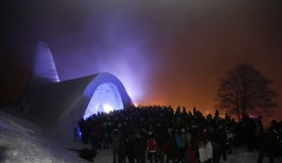 People wait outside a Catholic church made of snow in the Bavarian village of Mitterfirmiansreut, near the German-Czech border, December 28, 2011. The snow church is likely to become a tourist attraction till the beginning of spring.