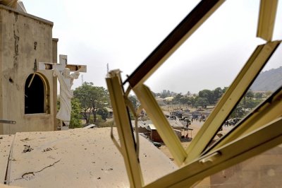 A crucifix stands near a damaged structure at the scene of a car bomb explosion at St. Theresa Catholic Church at Madalla, Suleja, just outside Nigeria's capital Abuja, on Dec. 25, 2011.