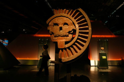 A visitor walks by the Teotihuacan culture Disk with a Skull at the temporary exhibition 'Isis and the feathered serpent' in Monterrey, Sept. 21, 2007. Ancient Mexicans and Egyptians, who never met and lived centuries and thousands of miles apart, both worshiped feathered-serpent deities, built pyramids and developed a 365-day calendar, a new exhibition shows.
