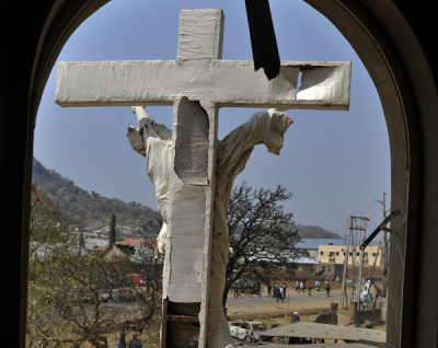 A damaged crucifix overlooks the scene of a bomb explosion at St. Theresa Catholic Church at Madalla, Suleja, just outside Nigeria's capital Abuja, on Dec. 25, 2011. 