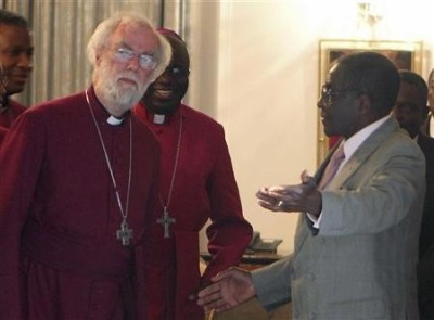 Zimbabwe's President Robert Mugabe welcomes the Archbishop of Canterbury Rowan Williams (L) for a meeting at the State House in Harare on Oct. 10, 2011.
