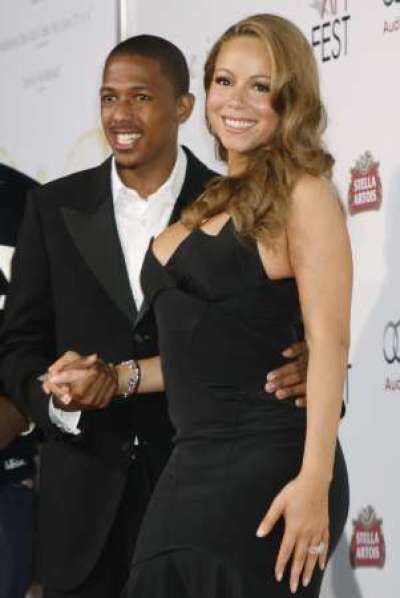 Actress Mariah Carey, star of the new film 'Precious: Based on the novel 'Push' by Sapphire', poses with her husband Nick Cannon at the AFI Fest 2009 gala screening of the film in Hollywood in this November 1, 2009 file photo. Mariah Carey and Nick Cannon have renewed their wedding vows in a Los Angeles hospital, just a day after the singer gave birth to twins. Civil rights activist the Rev. Al Sharpton said in a Twitter message on May 1, 2011 that he conducted a brief ceremony at the hospital, and also blessed the twins - a girl and a boy. Picture taken November 1, 2009.