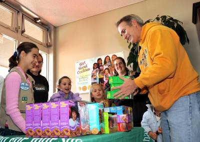 Capt. Eric Gardner, right, commanding officer of Naval Air Facility Atsugi, buys boxes of Girl Scout cookies from Girl Scouts at the base commissary in this Jan. 9, 2010, file photo.