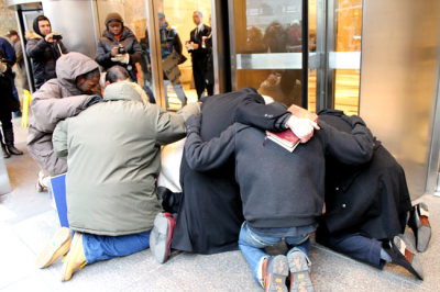 Dimas Salaberrios, pastor of Infinity Church in the Bronx borough of New York City, prays with supporters at the entrance of the offices of the New York City Law Department in downtown Manhattan on Jan. 5, 2012. Protesters voiced their opposition to Infinity Church's eviction from a New York City Housing Authority property used as a worship space.