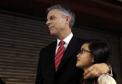 U.S. Republican presidential candidate former Utah Governor Jon Huntsman (L) stands with his daughter Gracie Mei before his Lincoln Douglas style debate with fellow Republican candidate and former U.S. House Speaker Newt Gingrich at St. Anselm College in Manchester, New Hampshire December 12, 2011.