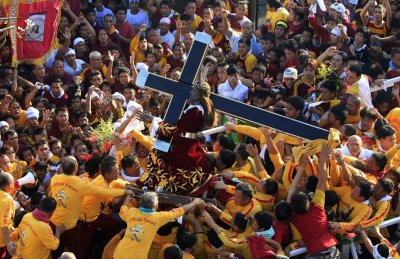 Devotees carry a statue of the Black Nazarene during the start of the annual religious procession on January 8, 2012, in Manila, Philippines.