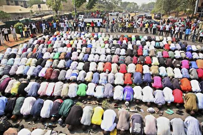Muslims pray while Christians form a protective human chain around them during a protest against the elimination of a popular fuel subsidy that has doubled the price of gas in Nigeria's capital Abuja, Jan. 10, 2012.