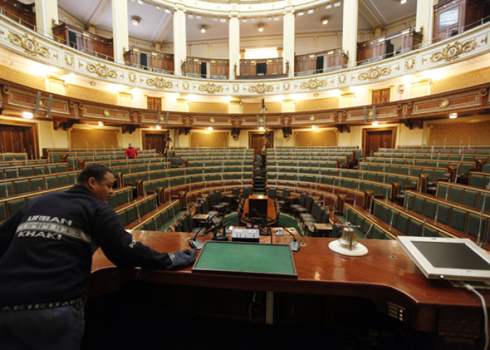 A worker cleans the table of the Egyptian parliament in Cairo January 22, 2012. New elected members of Egypt's parliament will sit on Monday for the first time since the election.