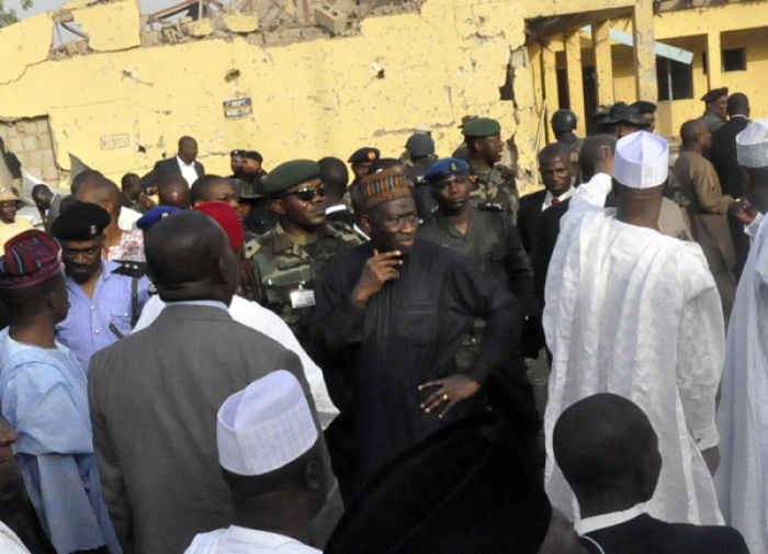 President Goodluck Jonathan (C) stands with government officials during his visit to the police headquarters in the northern city of Kano January 22, 2012, following a bomb attack on Friday. Gun and bomb attacks by Islamist insurgents in the northern Nigerian city of Kano last week killed at least 178 people, a hospital doctor said on Sunday, underscoring the challenge President Goodluck Jonathan faces to prevent his country sliding further into chaos.