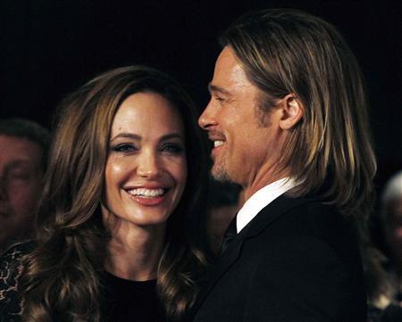Actress Angelina Jolie smiles with her partner Brad Pitt as they arrive at the 23rd annual Producers Guild Awards in Beverly Hills, Calif., Jan. 21, 2012. Jolie, who directed and produced the film "In The Land of Blood and Honey," and other producers of the film received the Stanley Kramer Award at the event.