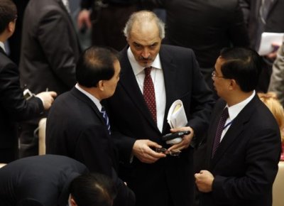 Syria's Ambassador to the United Nations (U.N.) Bashar Jaafari (C) speaks with China's Ambassador Li Baodong (L) as they arrive at the U.N. Security Council to discuss a European-Arab draft resolution endorsing an Arab League plan calling for Syria's President Bashar al-Assad to give up power in New York February 4, 2012. The Homs attack made Friday the bloodiest day of an 11-month uprising and it gave new urgency to a push by the Arab League, the United States and Europe for a U.N. resolution calling for Assad to cede power. The Security Council had scheduled an open meeting for Saturday to vote on the draft. But Russia asked that the 15-nation body not immediately do so and instead hold consultations.