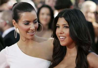 Reality star Kim Kardashian (L) and sister Kourtney Kardashian arrive on the red carpet at the 61st annual Primetime Emmy Awards in Los Angeles, California