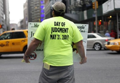 A volunteer from Harold Camping's Family Radio holds a sign with warnings of Judgment Day at Times Square in New York City on May 13, 2011. (File)