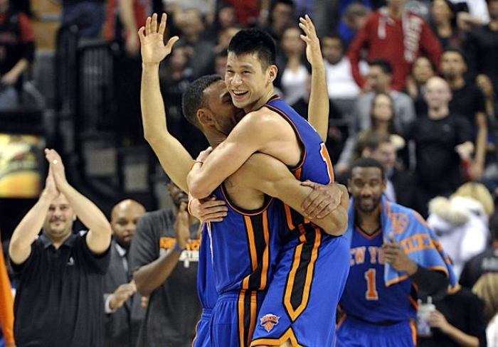 New York Knicks guard Jeremy Lin (R) and Jered Jeffries celebrate their win against the Toronto Raptors during their NBA basketball game in Toronto Feb, 14, 2012.