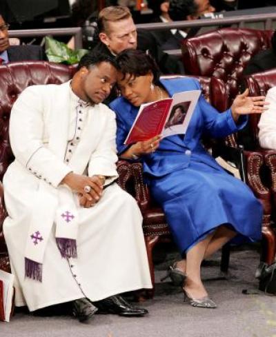 The Rev. Bernice King (R) speaks to Bishop Eddie Long during a service at the New Birth Missionary Baptist Church in Lithonia, Ga., in this Feb. 7, 2006 file photo.