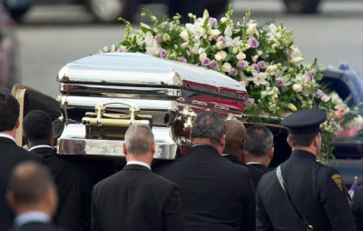 Pall-bearers carry the casket of pop singer Whitney Houston to a hearse following her funeral service at the New Hope Baptist Church in Newark, New Jersey February 18, 2012. Houston, 48, died in a Beverly Hills hotel room on February 11, the eve of the music industry's Grammy Awards.