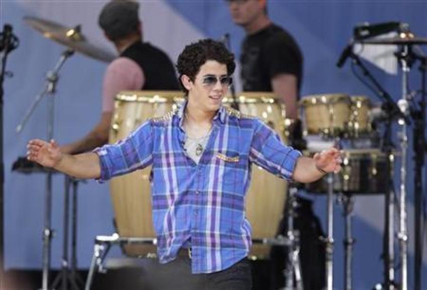 Singer Nick Jonas waves to the audience after performing on ABC's 