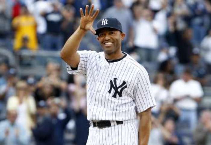 New York Yankees pitcher Mariano Rivera waves to fans after recording his career record 602nd save against the Minnesota Twins after their MLB American League baseball game at Yankee Stadium in New York September 19, 2011.