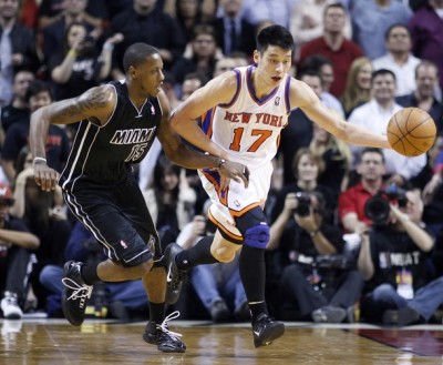Miami Heat's Mario Chalmers (L) reaches in for the ball against the New York Knicks' Jeremy Lin during their NBA basketball game in Miami, Florida Feb. 23, 2012.