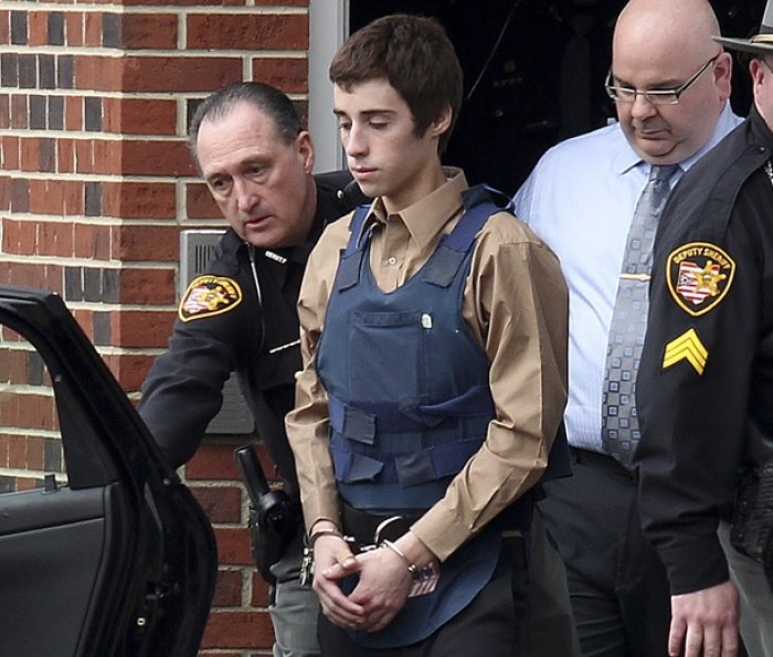 Suspect TJ Lane is escorted into the Geauga County Courthouse Annex by Sheriff deputies for his court appearance in Chardon, Ohio Feb. 28, 2012, after allegedly shooting and killing three students and wounding two others at Chardon High School.