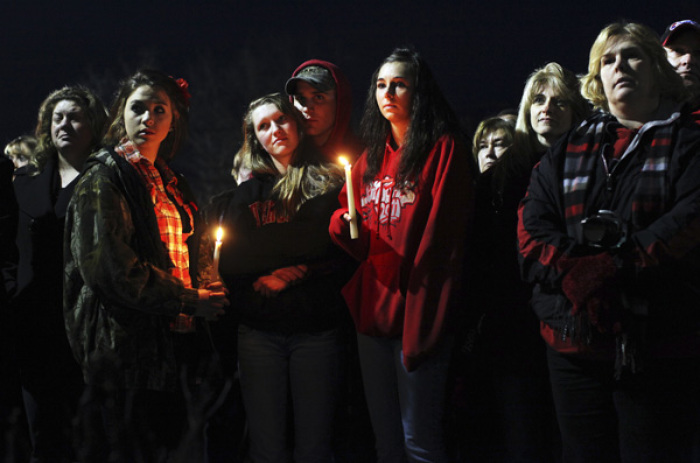 People gather outside St. Mary's of Chardon for a candlelight vigil remembering the victims of a school shooting in Chardon, Ohio February 28, 2012. Three students were killed and two others wounded by suspect TJ Lane in Monday's shooting rampage at the Ohio high school.