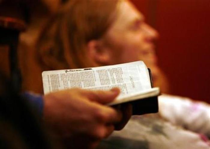 A man holds a bible during church services in this Feb. 18, 2007 file photo.