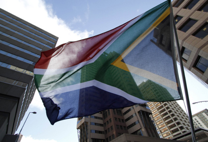 A South African waves a flag in Cape Town in this file photo.