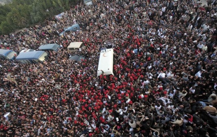 Military police and mourners surround the ambulance carrying the coffin of Pope Shenouda III, the head of Egypt's Coptic Orthodox Church, upon its arrival for burial at St. Bishoy Monastery in Wadi al-Natrun, 62 miles north of Cairo, on March 20, 2012.