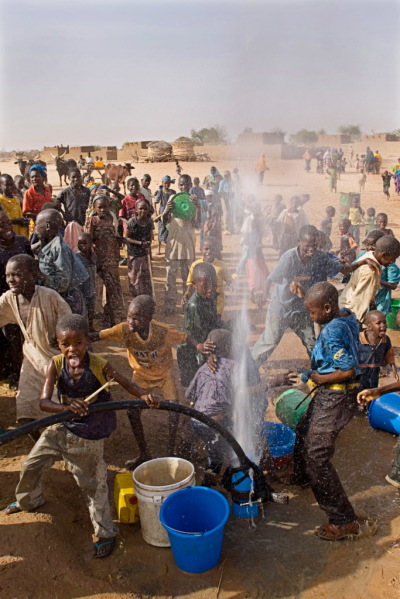 Children playing as World Vision drills a new borehole.