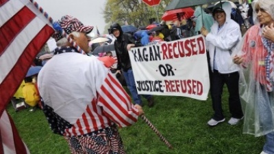 Members of the Tea Party Patriots hold sign in front of U.S. Supreme Court asking Justice Elena Kagan to recuse herself in Affordable Care Act (2010) case, March 24, 2012.