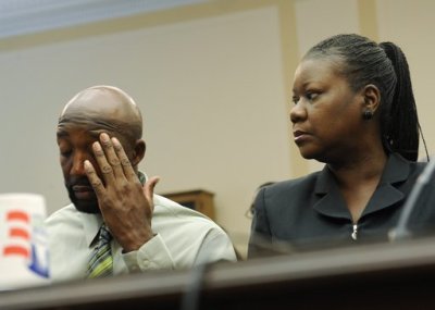 Tracy Martin, father of Florida shooting victim Trayvon Martin, wipes his brow next to Trayvon's mother Sybrina Fulton at a public forum on their son's case, on Capitol Hill in Washington, March 27, 2012. Trayvon, 17, was shot on February 26 by George Zimmerman, a neighborhood watch volunteer in a suburb of Orlando, Florida.