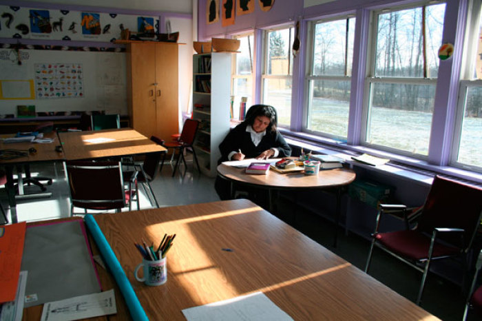 High school teacher Elva Jamieson marks student assignments in her classroom at the Gaweni:yo High School in the Six Nations Reserve January 31, 2008.