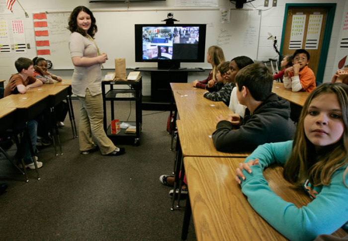 Students at Westside Middle School in Winder, Georgia, including Gabriela Unguryan (standing), answer questions via internet from a class at Charleswood Junior High School located in Winnipeg, Manitoba Canada during a cooperative education project with Canada on January 24, 2008. The campus of Westside Middle School is the host site where school officials, government leaders and partnerships from as far away as Canada gathered to view a new era in learning by bringing virtual experiences right into the classroom.