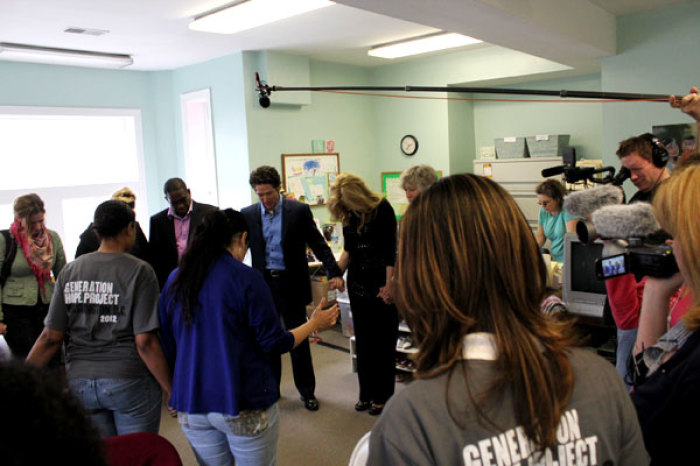 Joel Osteen and his wife, Victoria, hold hands with Capitol Hill Pregnancy Center staffs and Generation Hope Project volunteers to pray for the center and its work on Thursday, April 26, 2012, in Washington, D.C.