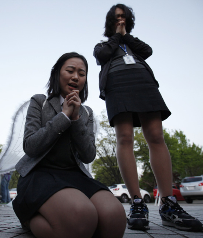 Christians attend a prayer meeting against the concert of U.S. singer Lady Gaga, in front of the Olympic stadium in Seoul April 27, 2012. Christian groups called for a boycott of her show, which they say promotes homosexuality.