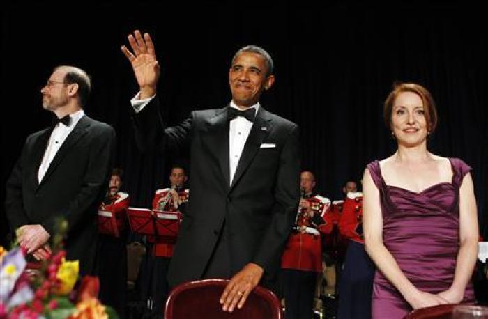 U.S. President Barack Obama (C) stands next to Reuters Editor-in-Chief Steve Adler (L) and WHCA President and Reuters correspondent Caren Bohan (R) as attends the White House Correspondents Association annual dinner in Washington April 28, 2012.