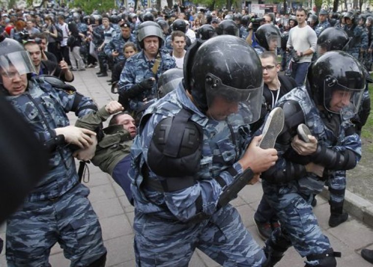 Riot police detain an opposition supporter during an unsanctioned protest in Moscow May 7, 2012.