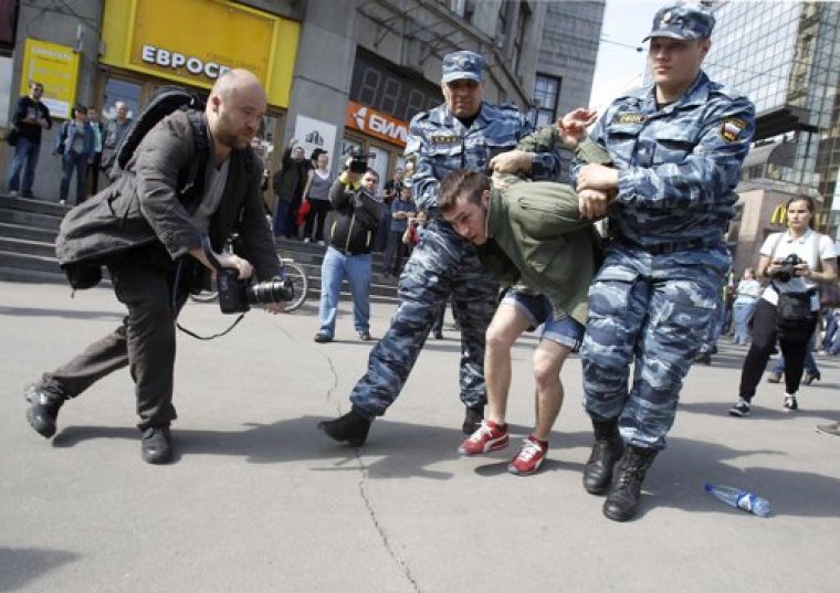 Members from Russia's Interior Ministry detain an opposition supporter during an unsanctioned protest in Moscow May 7, 2012.