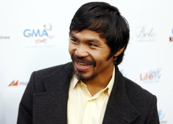 Filipino congressman and boxer Manny Pacquiao, the evening's guest host, poses at the North American premiere of the Filipino film 'The Road' at the Arclight Hollywood Theater in Los Angeles May 9, 2012.