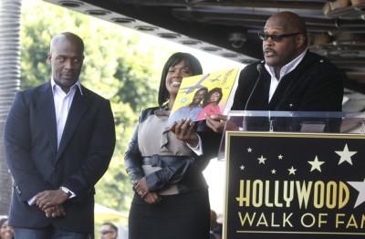 Grammy Award-winning brother and sister Gospel recording artists Bebe (L) and CeCe Winans listens as their brother Pastor Marvin Winans speaks and holds a copy of their first album during ceremonies unveiling their star on the Hollywood Walk of Fame in Hollywood Oct. 20, 2011.