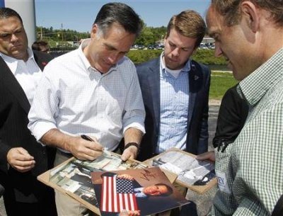 Republican presidential candidate and former Massachusetts Governor Mitt Romney signs autographs for supporters during a campaign event in Hillsborough, New Hampshire May 18, 2012.