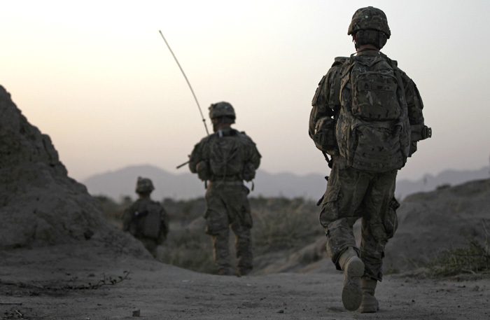 U.S. Army soldiers walk back to their base after a patrol near Combat Outpost Nolen in Arghandab Valley, north of Kandahar, in this April 2011 file photo.