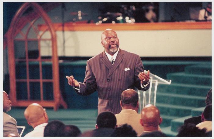 A photo taken in 1996 shows Bishop T.D. Jakes preaching during the early days of The Potter's House in Dallas. The church began with 50 families and has grown to 30,000 members.