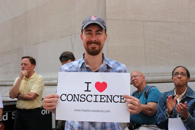 A protester holds a sign at the Stand Up for Religious Freedom Rally in New York City on June 8, 2012 in opposition to President Barack Obama's Affordable Care Act.