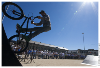 A rider on a BMX bike performs a trick for Folsom State Prison inmates during a Operation Starting Line/Luis Palau Association event.